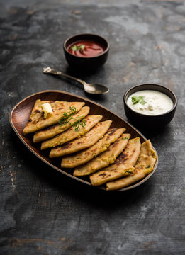 Aloo Paratha / Indian Potato stuffed Flatbread. Served with fresh curd and tomato ketchup. selective focus