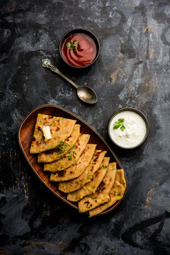 Aloo Paratha / Indian Potato stuffed Flatbread. Served with fresh curd and tomato ketchup. selective focus