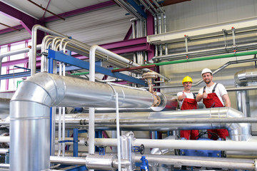 successful assemblers in industry - workers at the workplace are stretching their thumbs upwards ...