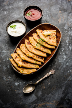 Aloo Paratha / Indian Potato stuffed Flatbread. Served with fresh curd and tomato ketchup. selective focus