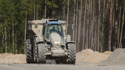 TRACTOR WITH A TRAILER - The vehicle on construction site © Wojciech Wrzesień