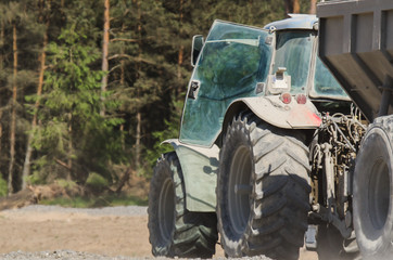 TRACTOR WITH A TRAILER - The vehicle on construction site © Wojciech Wrzesień