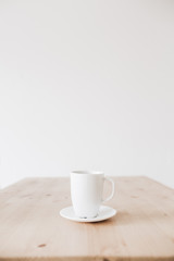 Cup of coffee on clean wooden table. Flat lay, top view background.