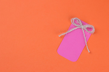 Black Friday. The concept of shopping. sale. Pink sale price tag on orange background. view from above