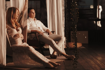 Obraz premium concept family pregnancy home comfort / husband and pregnant wife with a big belly in a cozy home environment