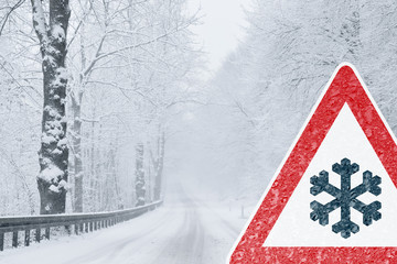 Winter Driving - Snowy Road with Warning Sign 