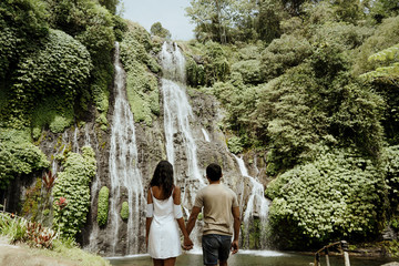 lovely couple enjoy banyumala waterfall bali together
