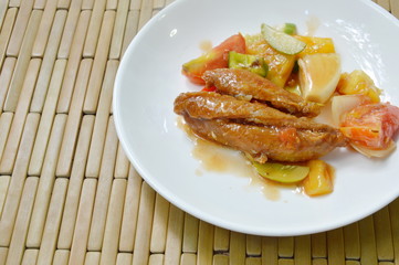 deep fried fish in sweet and sour gravy sauce on white plate