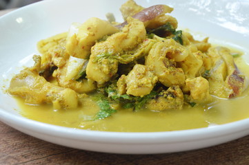 stir fried squid with yellow curry on plate