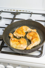 Fry chicken legs in a pan with spices.