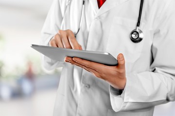 Close-up Doctor at hospital working with tablet