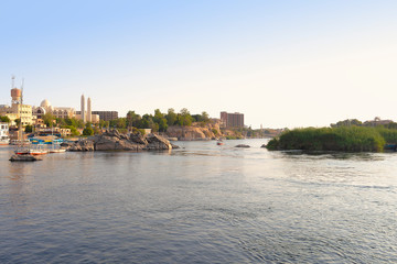 Naklejka premium View of Nile river in Aswan with Coptic orthodox cathedral of the Archangel Michael at sunset