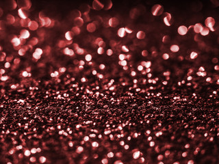 Background sequin. Red sparkle . glitter surfactant. Holiday abstract glitter background with blinking lights. Fabric sequins in bright colors. Fashion fabric glitter, sequins. Defocused.