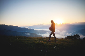 Young Pretty Girl Walk through the Morning Mountain Landscape