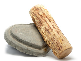 Thanaka wood and Kyauk pyin stone slab on white background (Isolated background). The Tanaka is popular with Burmese women. The face to make a beautiful white face.