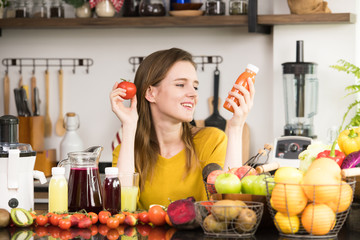Healthy young woman in a kitchen with fruits and vegetables and juice