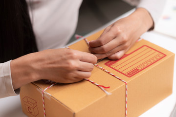 Closeup of a worker hands packing a box