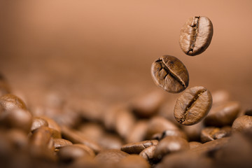 Coffee beans falling on pile
