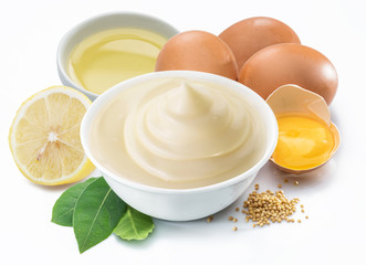 Mayonnaise sauce in white bowl with mayonnaise ingredients.