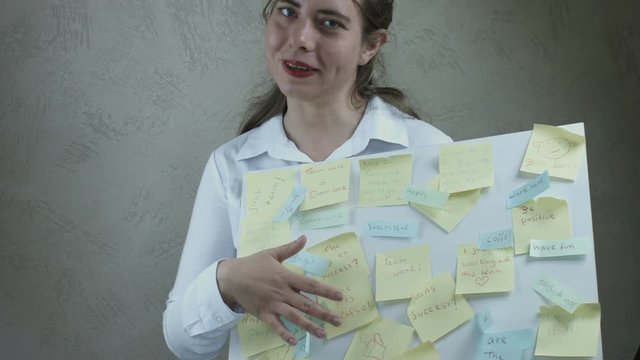 Business Woman Showing and Explaining Corporate Notes Board