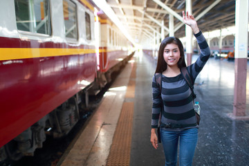 young traveler woman with backpack waiting for train