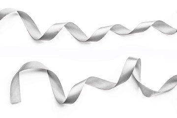 Silver ribbon bow in bright silver white grey color isolated on white background with clipping path for holiday and party greeting card design decoration element.