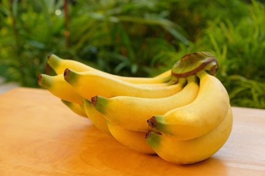 Fresh bananas on wooden table