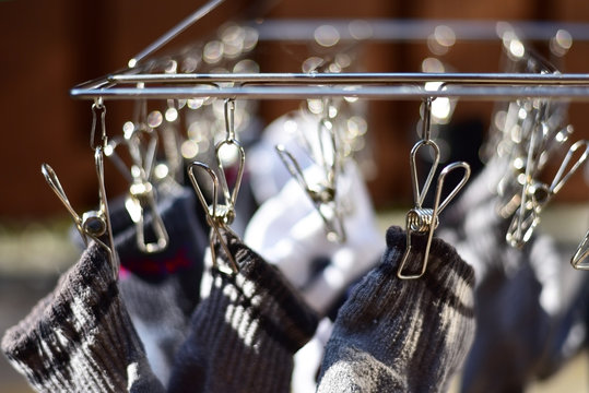 Socks hanging on the clip for dry clothes. Sock dry. A device that helps keep socks dry. Clothespin stainless steel wire with black socks dry up.