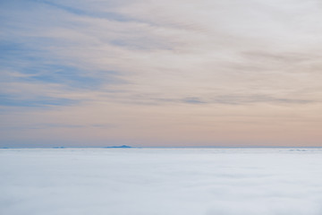 Obraz premium Above white heavy clouds. Panorama of cloudscape from the top of the mountain.
