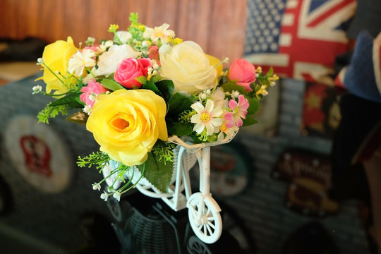 Toy car and a beautiful bouquet of plastic flowers.