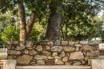 stone bench under tree in outdoor park environment, south country in Mediterranean district and...