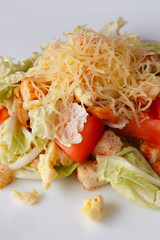 Salad from vegetables and meat on a white background.