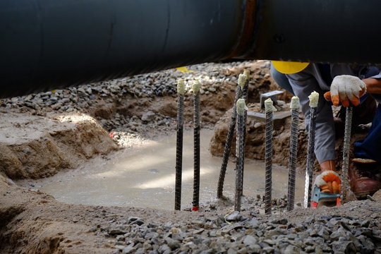 Workers are cutting off steel bar