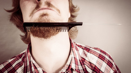 Man combing his beard