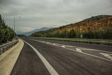 industrial and transport concept of empty free European highway between mountains scenery landscape in cloudy and rainy weather
