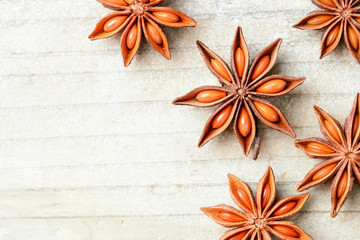 star anise fruits on the wooden board, top view