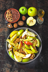 Vegan apple salad in a bowl. Healthy salad with apples, walnuts, spices and flax seeds. Useful autumn apple and nut salad. Fitness salad with seeds, nuts and apples. Healthy nutrition concept. Keto 