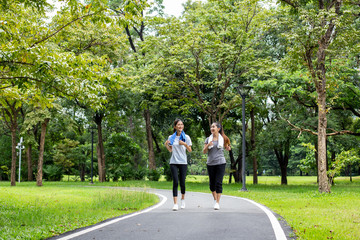 Fototapeta na wymiar Woman running with friend at garden. Women resting at garden together in holiday. People with lifestyle, relax, holiday concept.