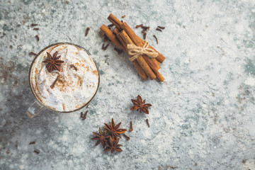 Chai latte and ingredients on concrete background, toned