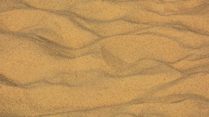 closeup of sand pattern of a beach in the summer