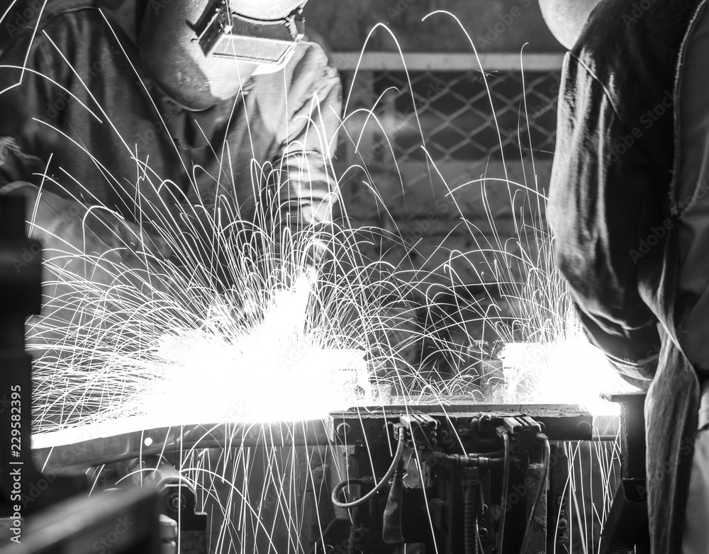 Wall mural worker with protective mask welding metal, black&white