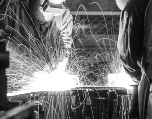 worker with protective mask welding metal, Black&White