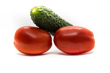 two red tomatoes and one green cucumber