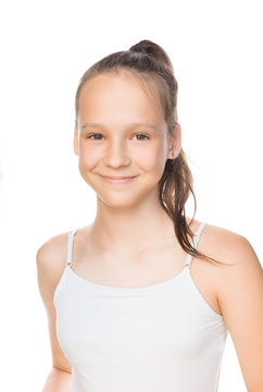 Beautiful smiling caucasian preteen girl in tank top with ponytail isolated on white. Studio portrait