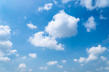 The blue sky with moving white clouds. The sky is a beautiful color shade suitable for use as a background image.