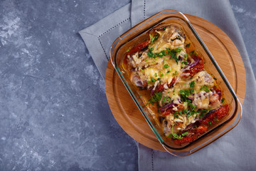 baked chicken legs with tomatoes and onions and cheese Chicken Casserole Menu and Restaurant Concept On a gray background