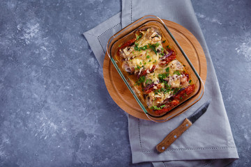 baked chicken legs with tomatoes and onions and cheese Chicken Casserole Menu and Restaurant Concept On a gray background