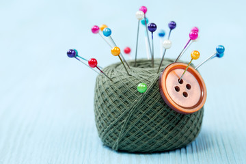 still life of spools of thread on a wooden background