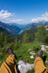 Hiker's feet in front of a Bavarian lake in the German alps.