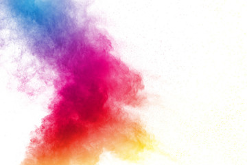 Abstract multi color powder explosion on white background.  Freeze motion of  dust  particles splashing. Painted Holi in festival.